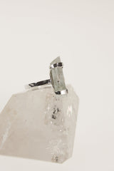Side view of handmade Aquamarine ring showing the raised blue beryl stone, oxidized silver setting, and hammered band.