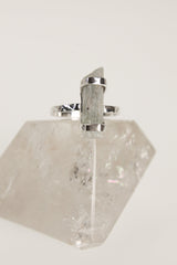 Australian Aquamarine sterling silver ring displayed on clear quartz, with hammered band and pale ocean-blue gemstone.