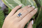 Handmade oxidized 925 sterling silver Australian Ocean Kyanite ring shown worn on the hand, with raw blue crystal and hammered band.