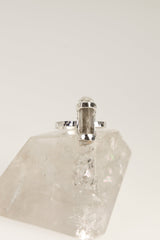 Side view of raw Aquamarine sterling silver ring showing the raised crystal form, hammered band, and handmade setting.