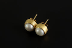 South Sea Pearl stud earrings displayed on dark background, with warm gold-plated sterling silver settings.