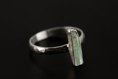 Side view of long square cut Aquamarine ring showing raised gemstone setting and high-polish sterling silver band.
