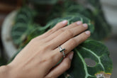 Green Tourmaline silver ring shown worn on a hand, with polished hammered sterling silver and forest-green gemstone.