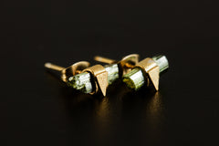 Handmade Green Tourmaline stud earrings displayed on dark background with raw stones and triangle settings.