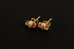Pink Tourmaline triangle stud earrings shown on a dark background, with raw crystals and gold-plated sterling silver settings.