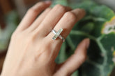 Long square cut Aquamarine silver ring shown worn on a hand, with polished hammered sterling silver and blue gemstone.