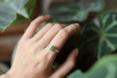 Green Tourmaline silver ring shown worn on a hand, with polished hammered sterling silver and forest-green gemstone.