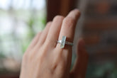 Green Tourmaline silver ring shown worn on a hand, with polished hammered sterling silver and forest-green gemstone.