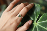 Green Tourmaline silver ring shown worn on a hand, with polished hammered sterling silver and forest-green gemstone.