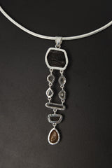 Emerald Dravite Herkimer Aquamarine Tiger Eye pendant shown worn on a silver choker with long linked gemstone design.