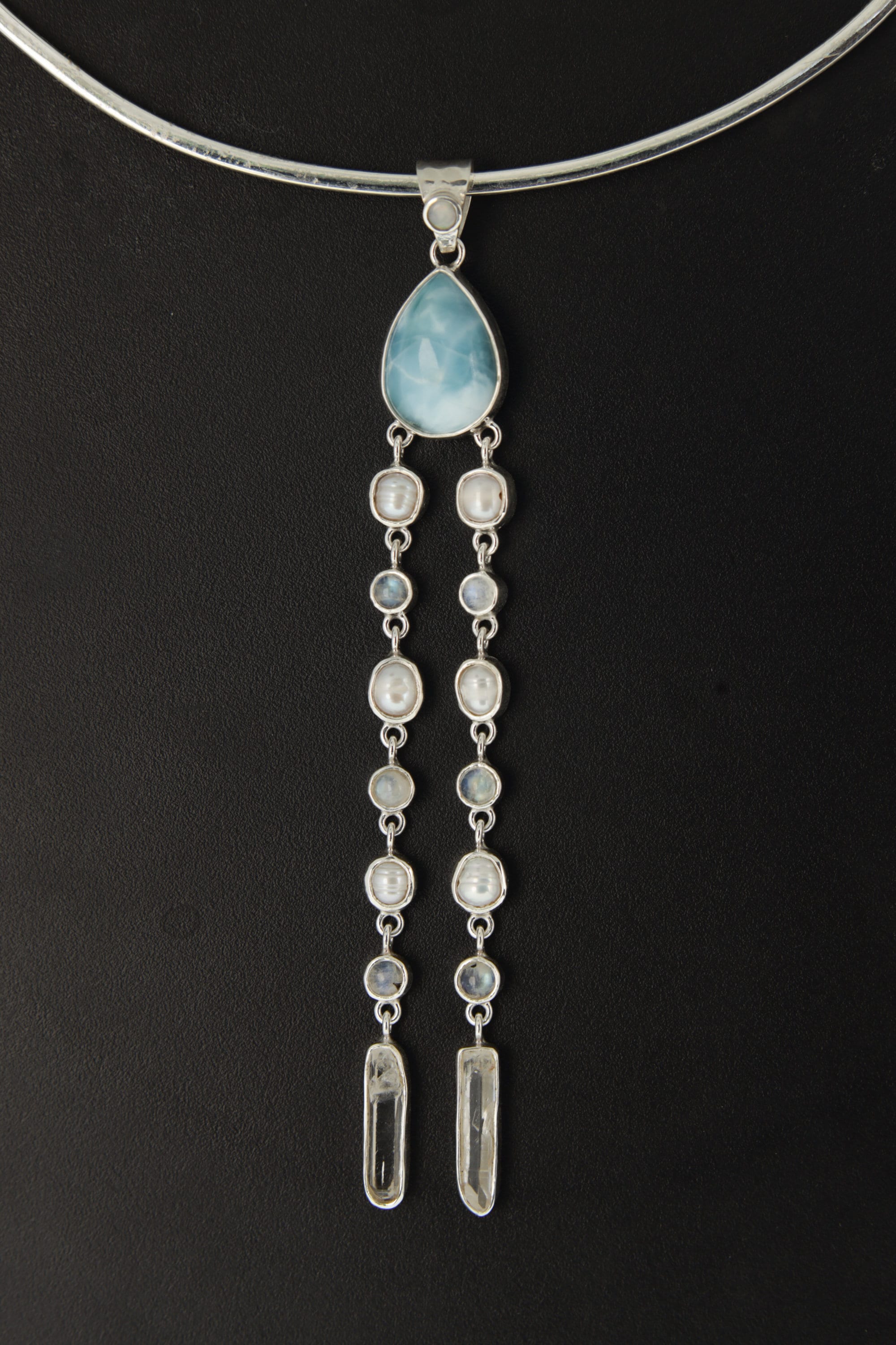 Lightning Ridge Opal Larimar Pearl Moonstone Quartz pendant shown worn on the chest with luminous sterling silver setting.