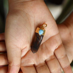 Mystic Ocean Whisper Quartz Larimar pendant held in hand showing dark Smoky Phantom Quartz and gold-plated silver cap.