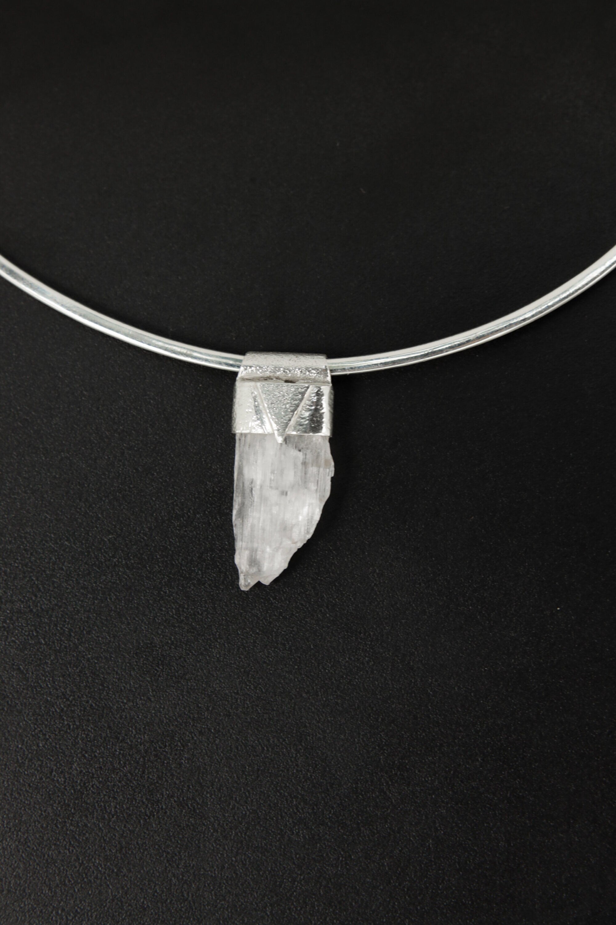 Unpolished Light Pink Kunzite Stack Pendant shown on black background with sterling silver cap and raw lilac crystal.