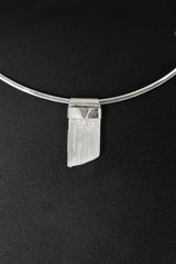 Translucent Selenite Stack Pendant shown on black background with pale crystal body and handmade sterling silver cap.