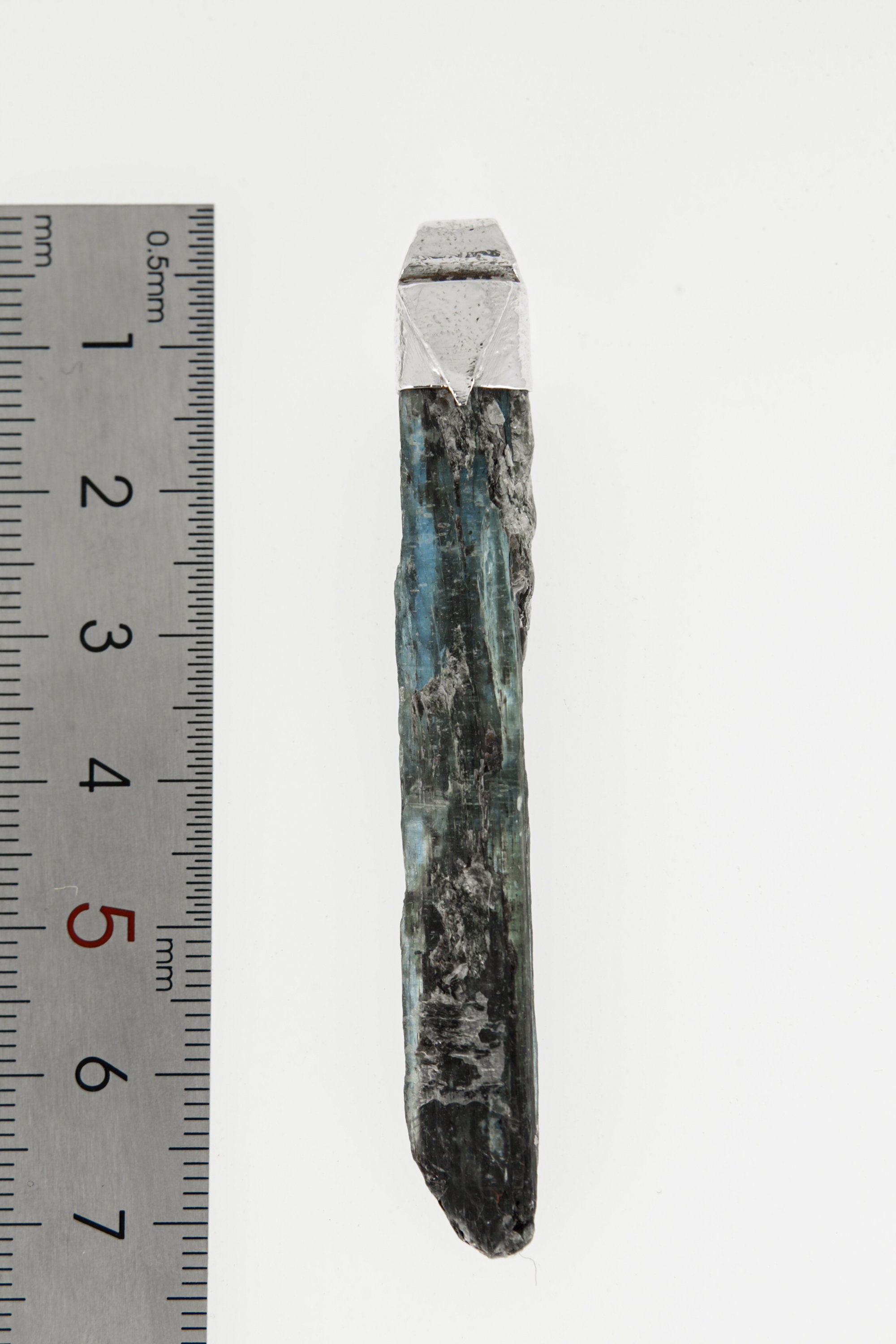 Australian Ocean Kyanite Stack Pendant shown beside a ruler for scale with textured 925 silver cap and blue crystal body.