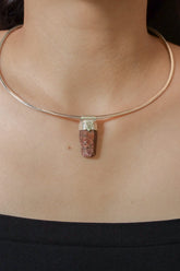 Hexagonal Ruby Stack Pendant shown worn on the chest with sterling silver cap and raw red gemstone body.
