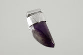 Tooth Shaped Amethyst Cabochon Stack Pendant shown on light background with sterling silver cap and polished purple stone.