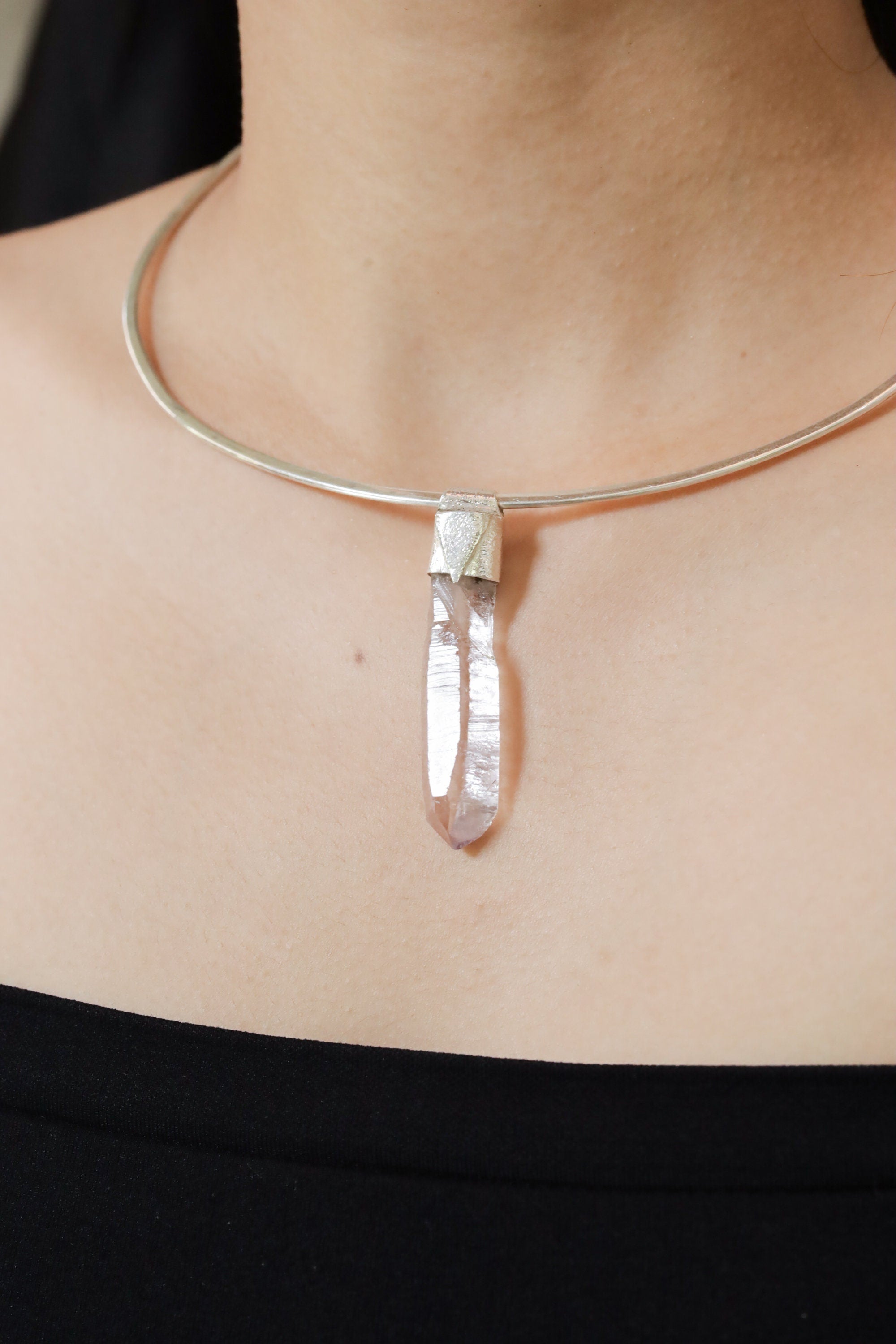 Anhydro Lemurian Vera Cruz Amethyst Stack Pendant shown worn on the chest with sterling silver cap and pale violet crystal.