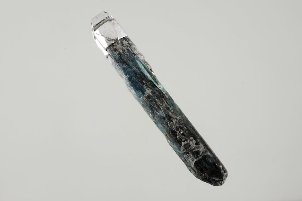 Australian Ocean Kyanite Stack Pendant shown on black background with adjustable black cotton necklace and textured silver cap.