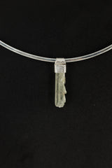 Skeletal Aquamarine Stack Pendant shown on black background with hand-hammered silver cap and slim raw crystal.
