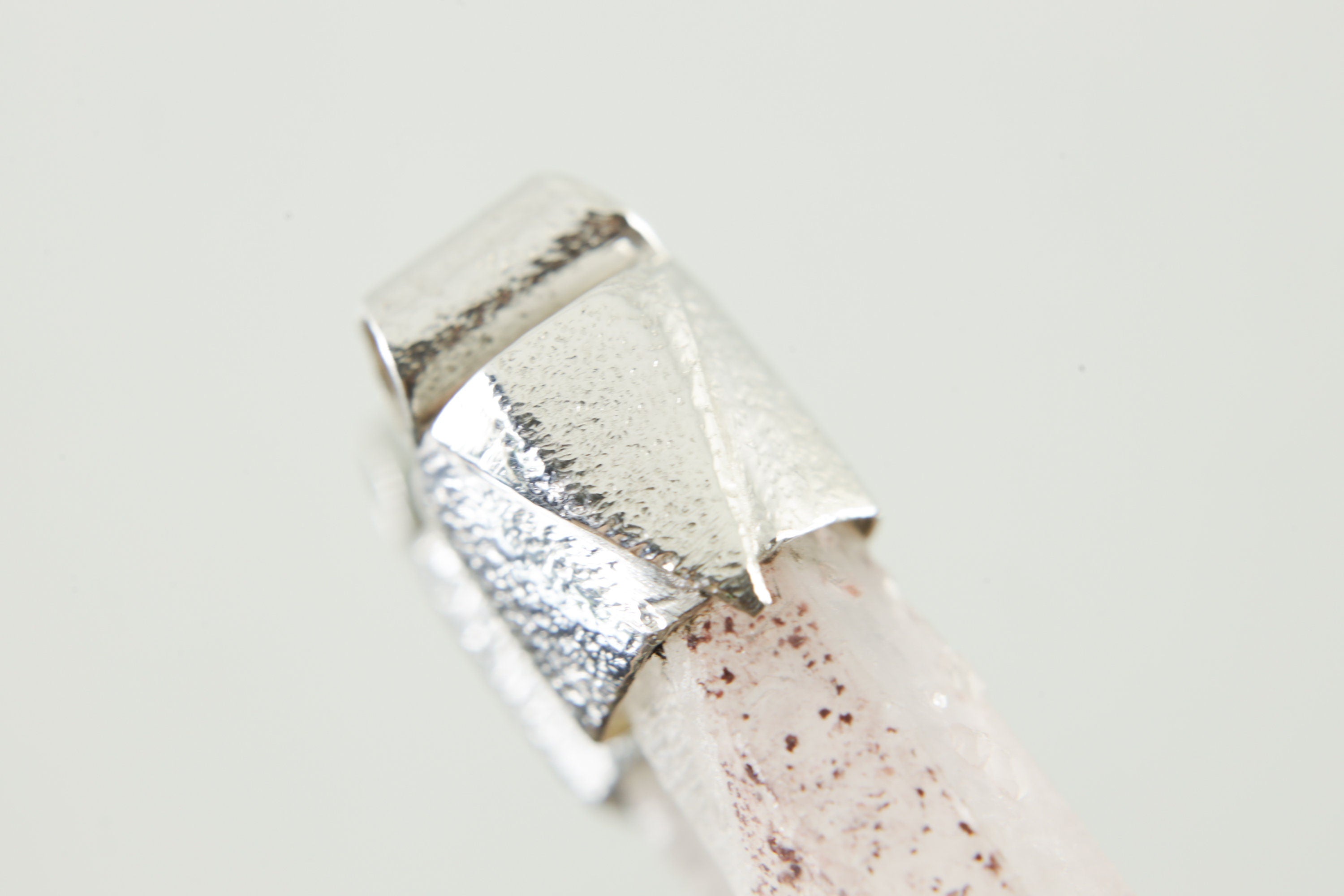 Close-up of Australian Phantom Lithium Quartz with soft lithium-bearing inclusions and handmade sterling silver cap.