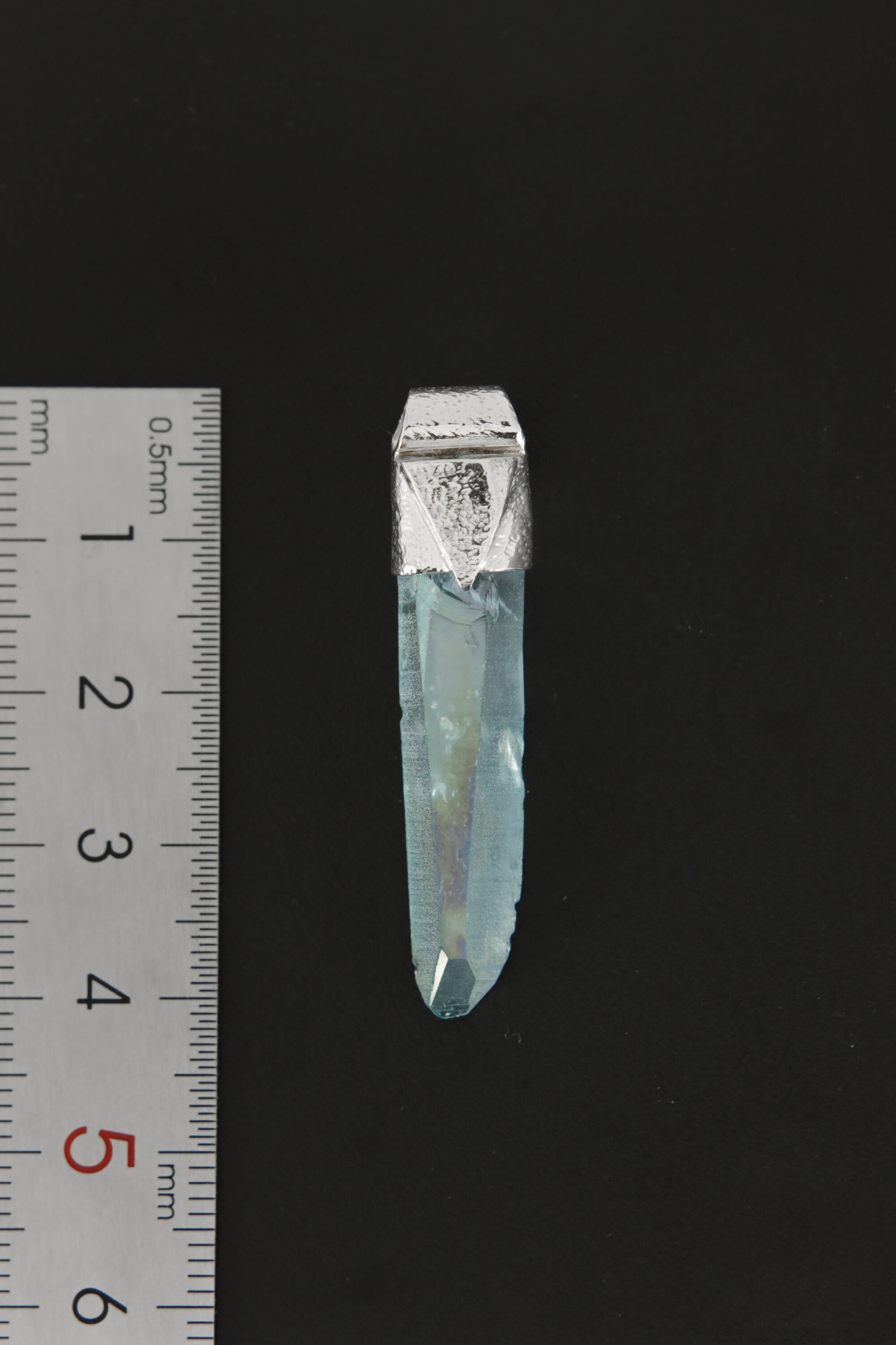 Lemurian Laser Aqua Aura Quartz Stack Pendant shown beside a ruler for scale with 925 silver cap and blue crystal point.