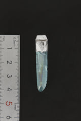 Lemurian Laser Aqua Aura Quartz Stack Pendant shown beside a ruler for scale with 925 silver cap and blue crystal point.