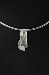 Polished Clear Himalayan Spodumene Stack Pendant shown on a black background with textured sterling silver cap.