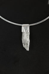 Hiddenite Stack Pendant shown on black background with sterling silver cap and pale green Spodumene crystal.