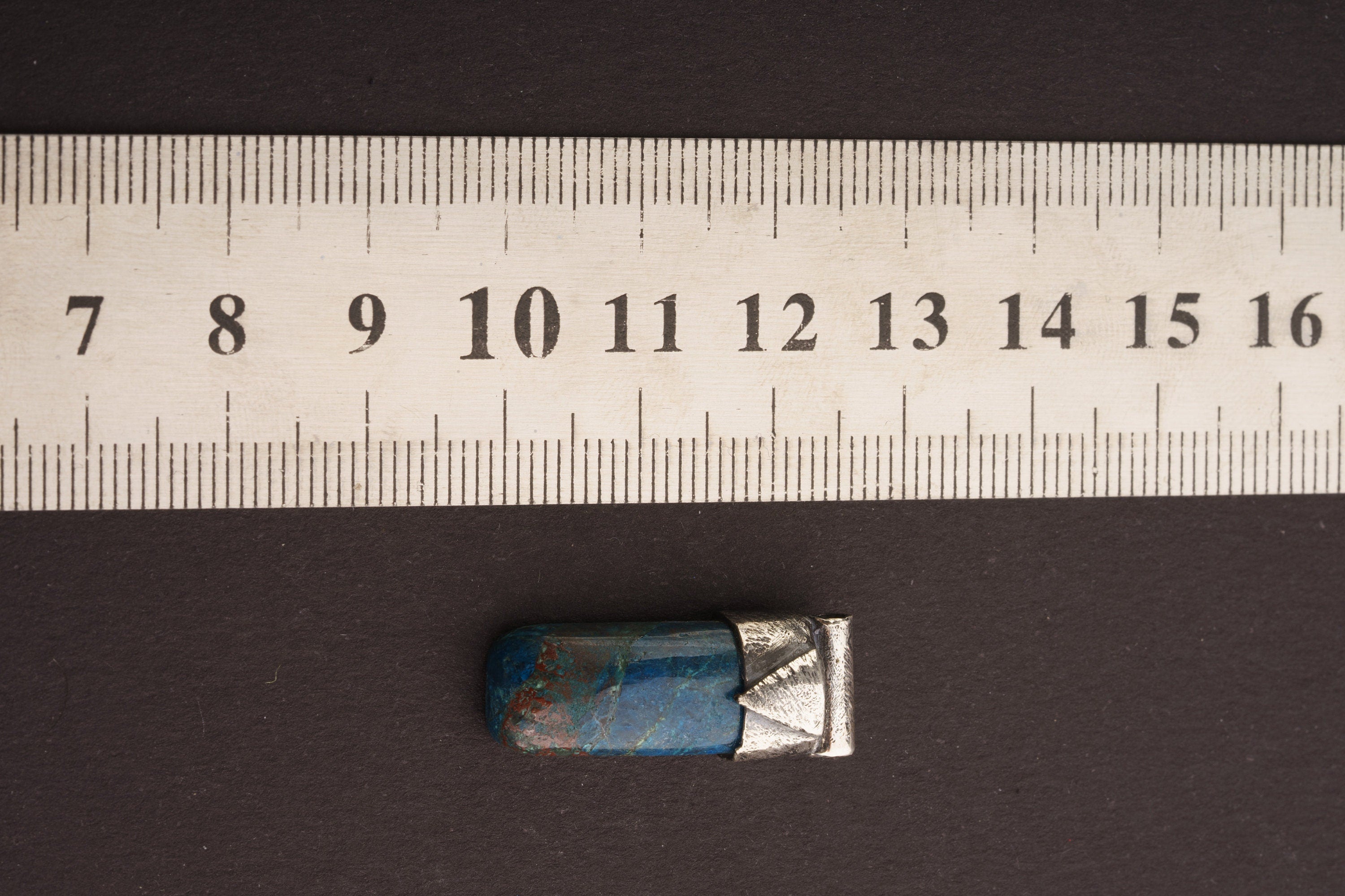 Azurite Stack Pendant shown beside a ruler for scale with 925 silver cap and blue copper mineral stone.