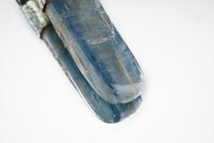 Close-up of polished Australian Ocean Kyanite showing blue-green colour, smooth surface, and organic sterling silver cap.