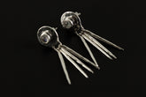 Handmade 925 sterling silver Blue Moonstone drop earrings shown on a dark background, with hammered circle settings and silver stick dangles.