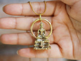 Gold-plated brass Bodhi pendant shown in hand, with sacred tree-inspired design and warm spiritual talisman finish.