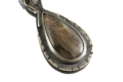 Teardrop Rainbow Labradorite held in textured oxidized sterling silver setting.