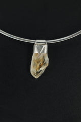 Natural Phantom Citrine Quartz Stack Pendant shown on black background with silver choker and golden crystal point.