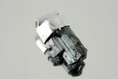 Green Tourmaline Stack Pendant shown on light background with raw Verdelite crystal and organic silver cap.