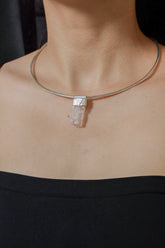 Light Pink Kunzite Stack Pendant shown worn on the chest with sterling silver cap and soft lilac-pink crystal.