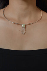 Polished Himalayan Spodumene Stack Pendant shown worn on the chest with sterling silver cap and clear crystal point.