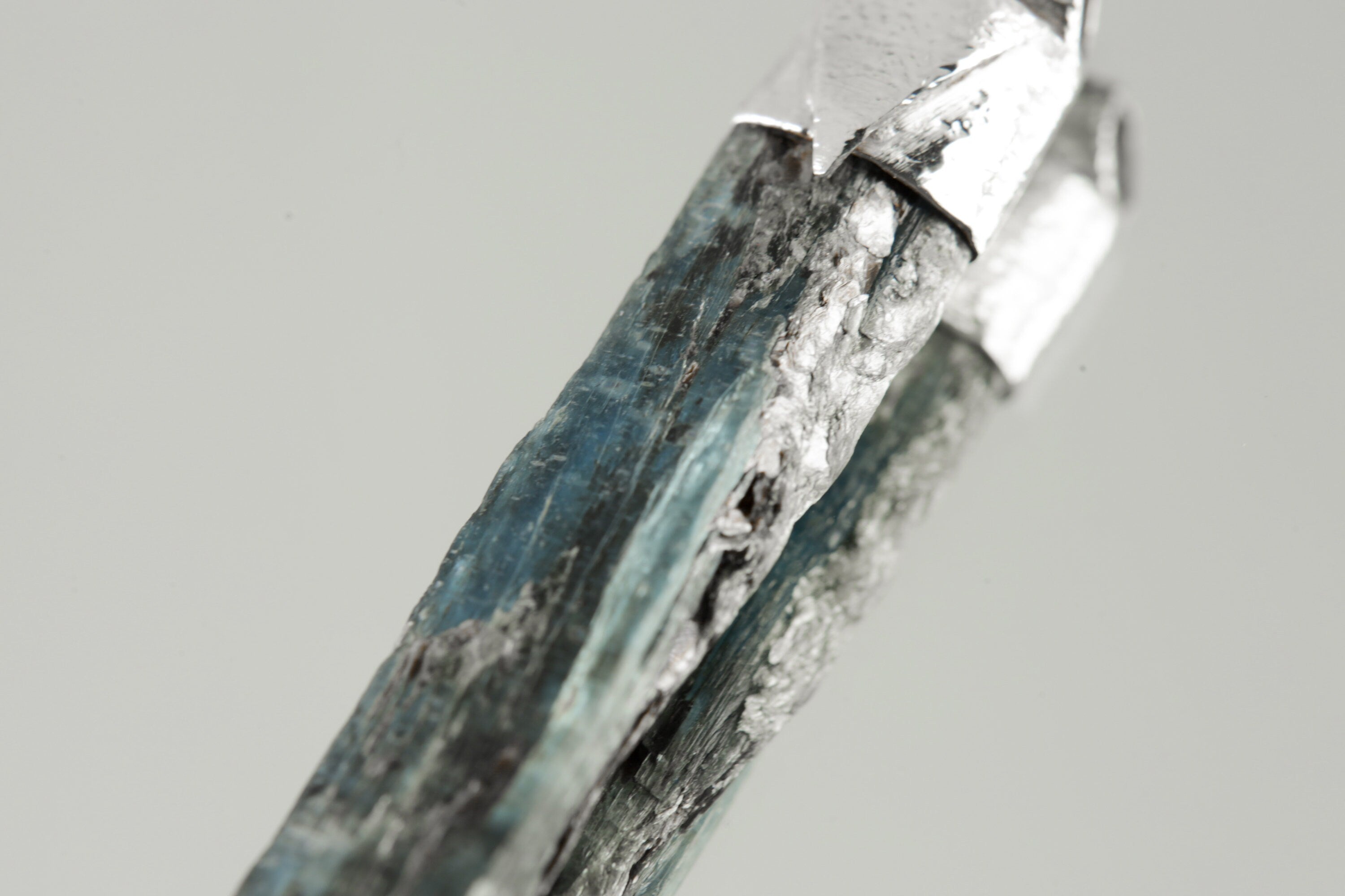 Close-up of Australian Ocean Kyanite showing blue mineral texture, natural silicate character, and organic sterling silver cap.