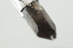 Close-up of Australian Smoky Phantom Window Quartz showing dark smoky colour, phantom layers, and natural crystal surface.