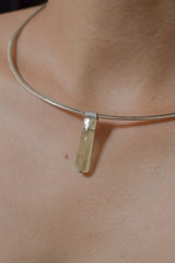 Skeletal Aquamarine Stack Pendant shown worn on the chest with silver choker and icy green-blue crystal.