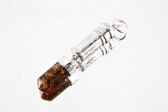 Brown Tourmaline Dravite capsule pendant on white background with polished sterling silver body and crystal point base.