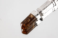 Close-up of Brown Tourmaline Dravite point set into a polished sterling silver capsule locket pendant.
