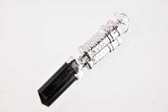 Black Tourmaline sterling silver capsule pendant worn on a model, showing polished silver locket and raw black crystal drop.