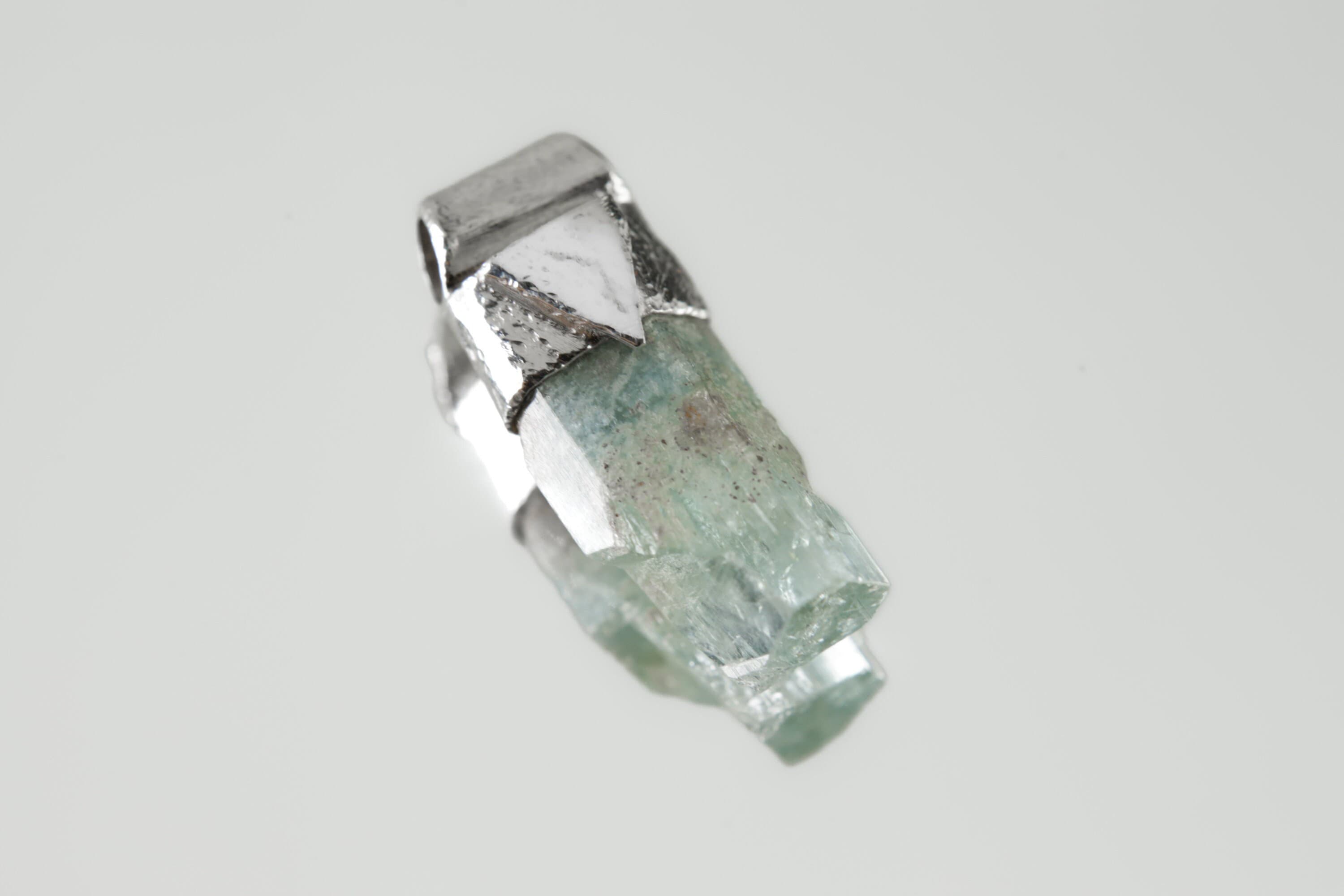 Natural Capped Aquamarine Stack Pendant shown on light background with textured sterling silver cap and soft blue-green crystal.