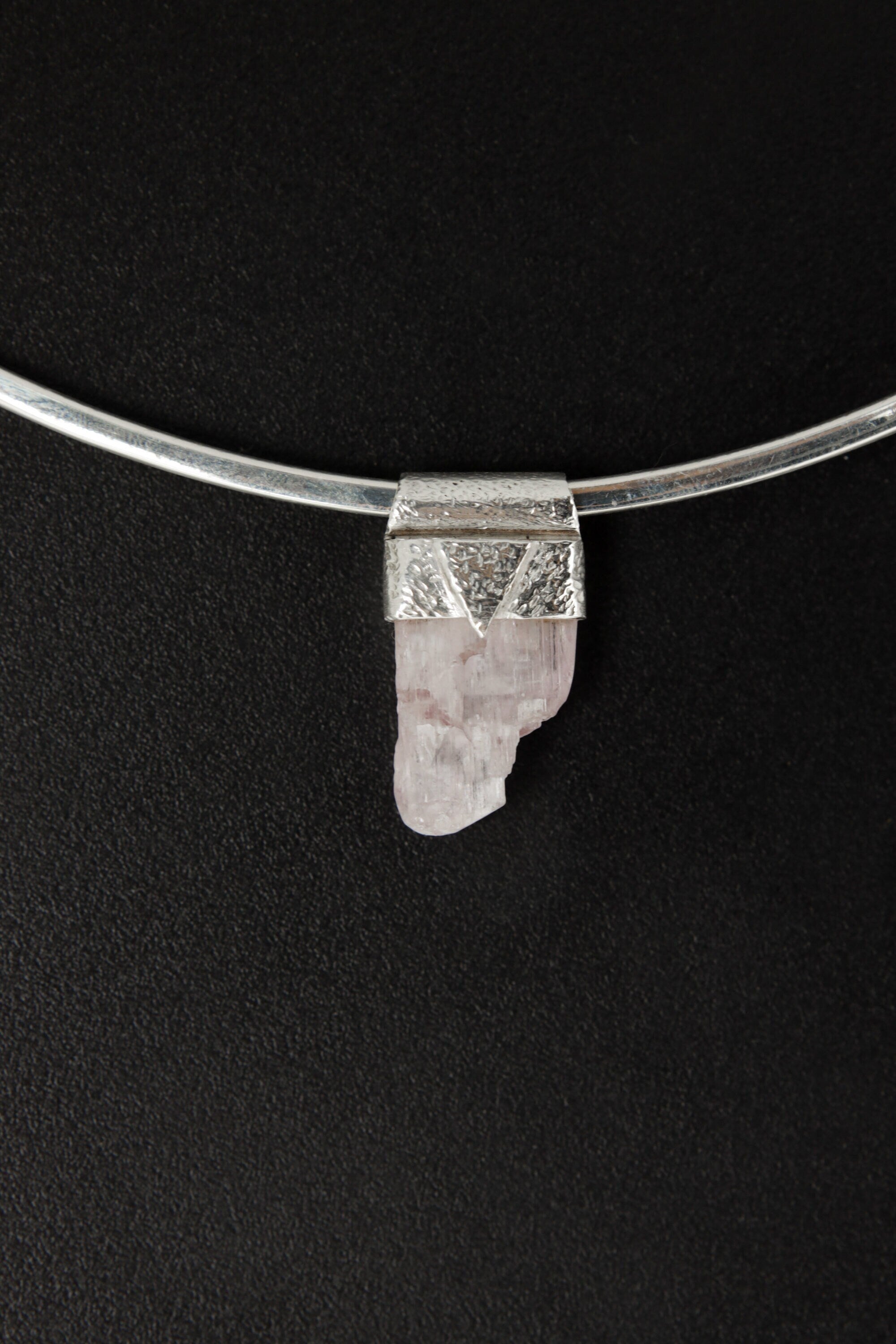 Light Pink Kunzite Stack Pendant shown worn on the chest with sterling silver cap and soft pink crystal.