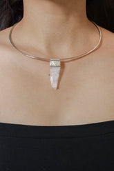 Himalayan Spodumene Stack Pendant shown worn on the chest with sterling silver cap and pale polished crystal.