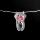 Ruby Ocean Kyanite sterling silver pendant displayed on black background with raw Record Keeper Ruby and blue Kyanite.