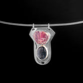 Ruby Ocean Kyanite sterling silver pendant displayed on black background with raw Record Keeper Ruby and blue Kyanite.