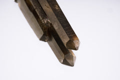 Close-up of Smoky Citrine Phantom Quartz showing twin crystal structure, smoky-golden tone, and natural point.